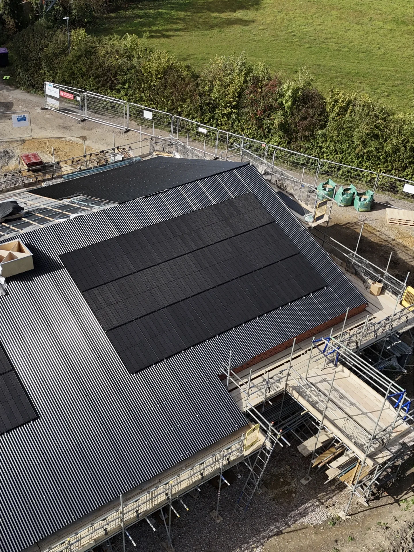 Large-scale commercial solar installation in progress on a warehouse roof